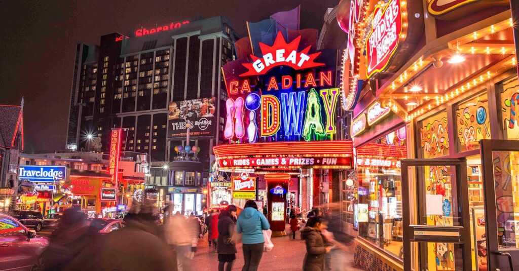 Experience the bustling and colorful night scene at the Great Canadian Midway in Niagara Falls, Ontario.